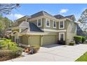 Side view of home showing the garage and driveway with mature landscaping at 490 Wekiva Preserve Dr, Apopka, FL 32712