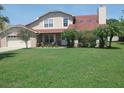Charming two-story home with a well-manicured lawn and inviting front porch at 5108 Avignon Ct, Orlando, FL 32839