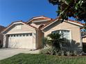 Home showcasing manicured landscaping and a two-car garage at 5337 Watervista Dr, Orlando, FL 32821