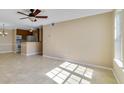 Bright living room with tile flooring, ceiling fan, and a view of the kitchen and natural light at 6142 Westgate Dr # 102, Orlando, FL 32835