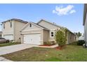 Single-story home with two-car garage and landscaped yard at 6745 Huntleigh Hammock Rd, Harmony, FL 34773