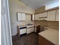 Functional kitchen featuring laminate countertops and white cabinetry, ready for updates at 6856 Ebans Bnd, Orlando, FL 32807