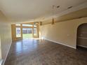 Spacious living room with high ceilings and sliding glass doors to backyard at 6856 Ebans Bnd, Orlando, FL 32807