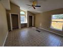 Bright main bedroom featuring vaulted ceiling, windows, and large closets at 6856 Ebans Bnd, Orlando, FL 32807