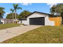 Charming single-story home with a two-car garage and a well-maintained front yard at 7427 Houston E Ct, Winter Park, FL 32792