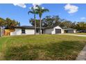 Charming single-story home with a two-car garage and a well-maintained front yard at 7427 Houston E Ct, Winter Park, FL 32792