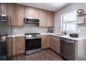 Modern kitchen featuring stainless steel appliances, light cabinets, and white countertops at 8042 Tompkins Sq, Orlando, FL 32807