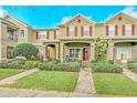 Inviting townhouse with brick pathway, manicured lawn, covered porch, and red shutters at 9130 Sabal Pine Way, Orlando, FL 32832