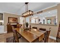 Open dining area with rustic lighting, wood table, and decorative accents at 1055 Kensington Park Dr # 402, Altamonte Springs, FL 32714