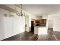 Open-concept dining area featuring wood-look floors, seamlessly connected to the adjacent kitchen space at 13028 Plantation Park Cir # 1218, Orlando, FL 32821