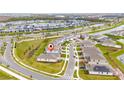 An aerial view showcases the home's location in a community near a green space and waterway at 13270 Panama Beach Ct, Orlando, FL 32827