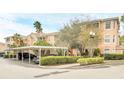 Condo building with covered parking and verdant landscaping at 13500 Turtle Marsh Loop # 839, Orlando, FL 32837