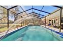 Inviting screened-in pool area with a spacious patio, perfect for outdoor relaxation and entertainment at 1461 Helena Ct, Deltona, FL 32725