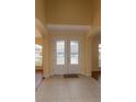 Bright foyer features double front doors with decorative glass and neutral tile flooring at 15313 Hayworth Dr, Winter Garden, FL 34787