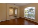 Inviting living room features wood floors, archways, and large window with neighborhood views at 15313 Hayworth Dr, Winter Garden, FL 34787