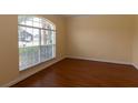 Neutral room with wood floors and a large window is ready for your personal touch at 15313 Hayworth Dr, Winter Garden, FL 34787