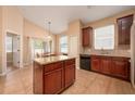 Kitchen with breakfast nook featuring an island and abundant natural light at 15341 Urbino Ln, Orlando, FL 32828