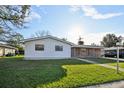 Charming single-story home with a well-maintained lawn and a brick accent wall at 2021 Canal Rd, Deltona, FL 32738