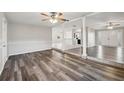 Bright and airy living room with new flooring, white trim, and ceiling fans at 2021 Canal Rd, Deltona, FL 32738