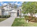 Charming two-story home with stone accents, well-manicured lawn, and attached garage at 221 Chippendale Ter, Oviedo, FL 32765