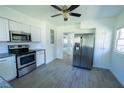 Well-lit kitchen featuring stainless steel appliances, granite countertops, and white cabinetry at 2401 S Myrtle Ave, Sanford, FL 32771