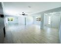 Bright and airy living room with modern light fixtures, wood look flooring, and a decorative fireplace at 2401 S Myrtle Ave, Sanford, FL 32771