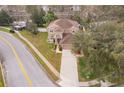 Aerial view of a two-story stucco home with an attached two-car garage, driveway, and landscaping at 2753 Joseph Cir, Oviedo, FL 32765