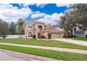 Charming two-story stucco home with well-manicured lawn and attached two-car garage in a suburban neighborhood at 2753 Joseph Cir, Oviedo, FL 32765