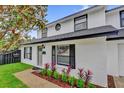 Charming two-story home featuring manicured landscaping with flowering bushes that lines the walkway at 2923 Cornell Ave, Orlando, FL 32804
