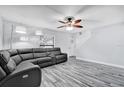 Bright living room features a large window, ceiling fan, and comfortable leather sofa at 2923 Cornell Ave, Orlando, FL 32804