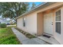 Exterior shot of the front entryway and an adjacent window, all set against green grass at 350 Lakebreeze Cir, Lake Mary, FL 32746