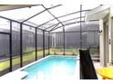 Private screened-in pool with string lights for evening relaxation at 4289 Prologue Way, Kissimmee, FL 34746