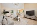 Bright and airy living room with modern furniture, a ceiling fan, and sliding glass doors at 4355 Watermill Ave, Orlando, FL 32817