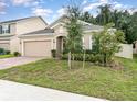 Single-story home with a brick driveway, lush lawn, and minimal landscaping at 515 Darshire Ave, Eustis, FL 32736