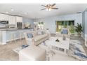 Open-concept living room with light blue walls, carpet, and sliding glass door at 515 Darshire Ave, Eustis, FL 32736