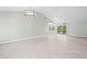 Bright and airy living room featuring tile floors, vaulted ceilings, and modern lighting at 517 Seville Ave, Altamonte Springs, FL 32714