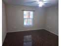 Bedroom featuring sleek wood flooring, a window with blinds, and neutral colored walls at 5459 Vineland Rd # 4310, Orlando, FL 32811