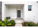 Charming front porch with stone steps and lush landscaping at 625 Trikomo Dr, Davenport, FL 33896