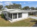 Bright single story home with a carport and a well-manicured lawn on a sunny day at 7 Great Oak Dr, Fruitland Park, FL 34731