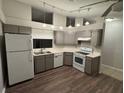 Functional kitchen featuring gray cabinets, stainless steel appliances, and vinyl flooring at 7277 Pebble Pass Loop Loop, Lakeland, FL 33810