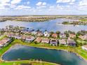 An elevated shot of this house and surrounding neighborhood located on a lake at 7515 John Hancock Dr, Winter Garden, FL 34787