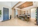 The dining room is well lit with modern furnishings and a rustic wood planked tray ceiling at 7515 John Hancock Dr, Winter Garden, FL 34787