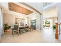 The dining room is open to the foyer and features a rustic wood planked tray ceiling at 7515 John Hancock Dr, Winter Garden, FL 34787