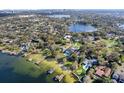 Expansive aerial of a waterfront homes and neighborhood with private docks and scenic lake views at 85 Interlaken Rd, Orlando, FL 32804