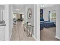 Bright hallway with modern tile flooring, leading to a bedroom and living area at 9017 Dogleg Dr, Davenport, FL 33896