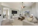 Inviting living room featuring a large window, comfortable seating, and a stylish entertainment center at 944 Glen Abbey Cir, Winter Springs, FL 32708