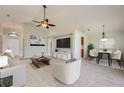 Bright living room with neutral tones, plush seating, modern decor, and an adjacent dining area at 944 Glen Abbey Cir, Winter Springs, FL 32708