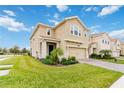 Charming home with a lush green lawn, well-kept landscaping, and a convenient two-car garage at 1100 Downswing Pl, Davenport, FL 33896