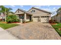 Beautiful single-Gathering home with a two-car garage, stone accents and meticulously maintained landscaping at 211 Venetian Palms Blvd, New Smyrna Beach, FL 32168