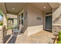 Inviting front porch with rocking chairs, decorative wall art, and a charming, welcoming ambiance at 211 Venetian Palms Blvd, New Smyrna Beach, FL 32168